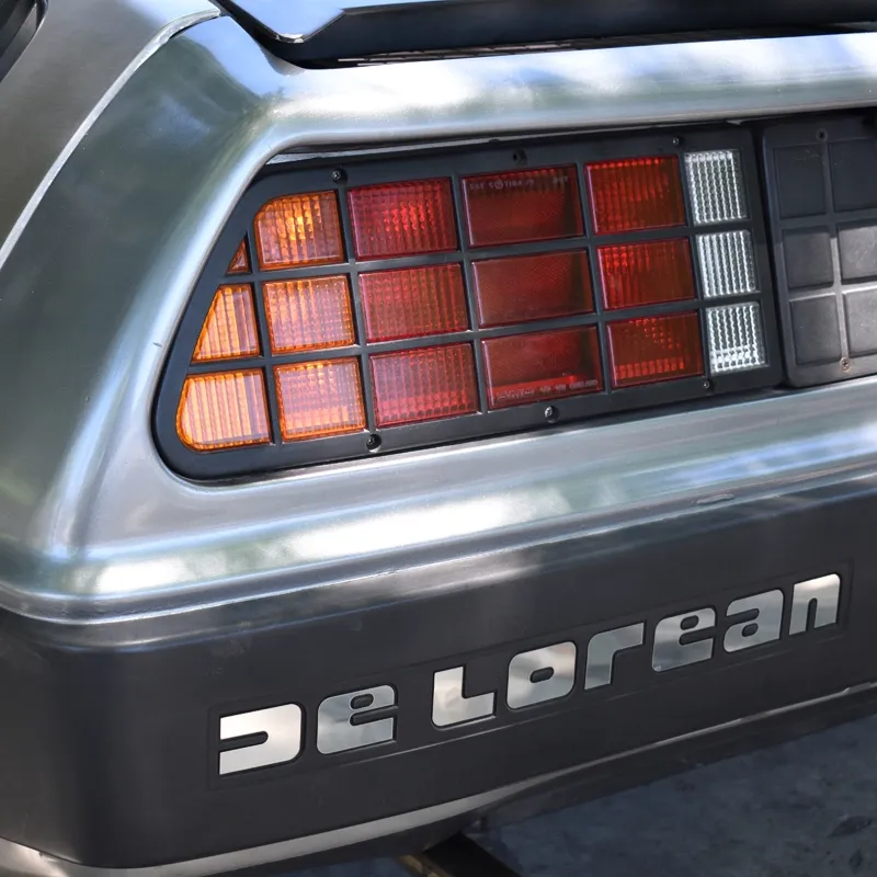 Guests posing near the DeLorean event car